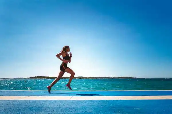 Woman running showing strong leg muscle Warrington